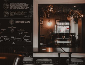 Modern pub interior with vintage map on wall, showcasing Cromford Canal locations and dimly lit cosy atmosphere