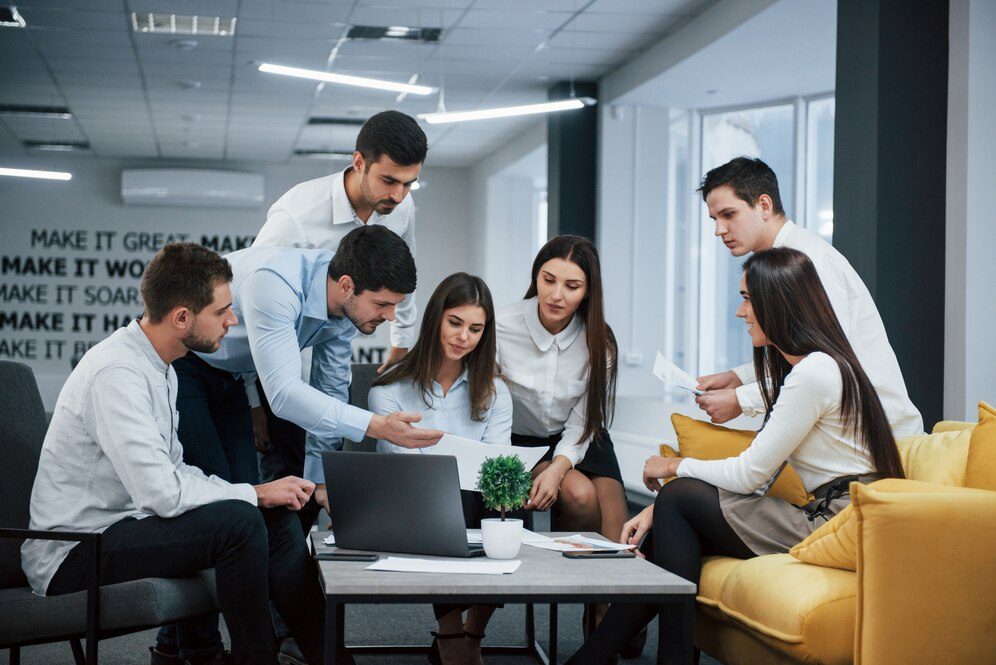 diverse group of business professionals collaborating around a conference table in a modern office setting