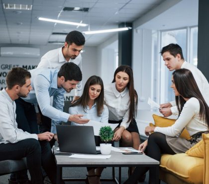 diverse group of business professionals collaborating around a conference table in a modern office setting